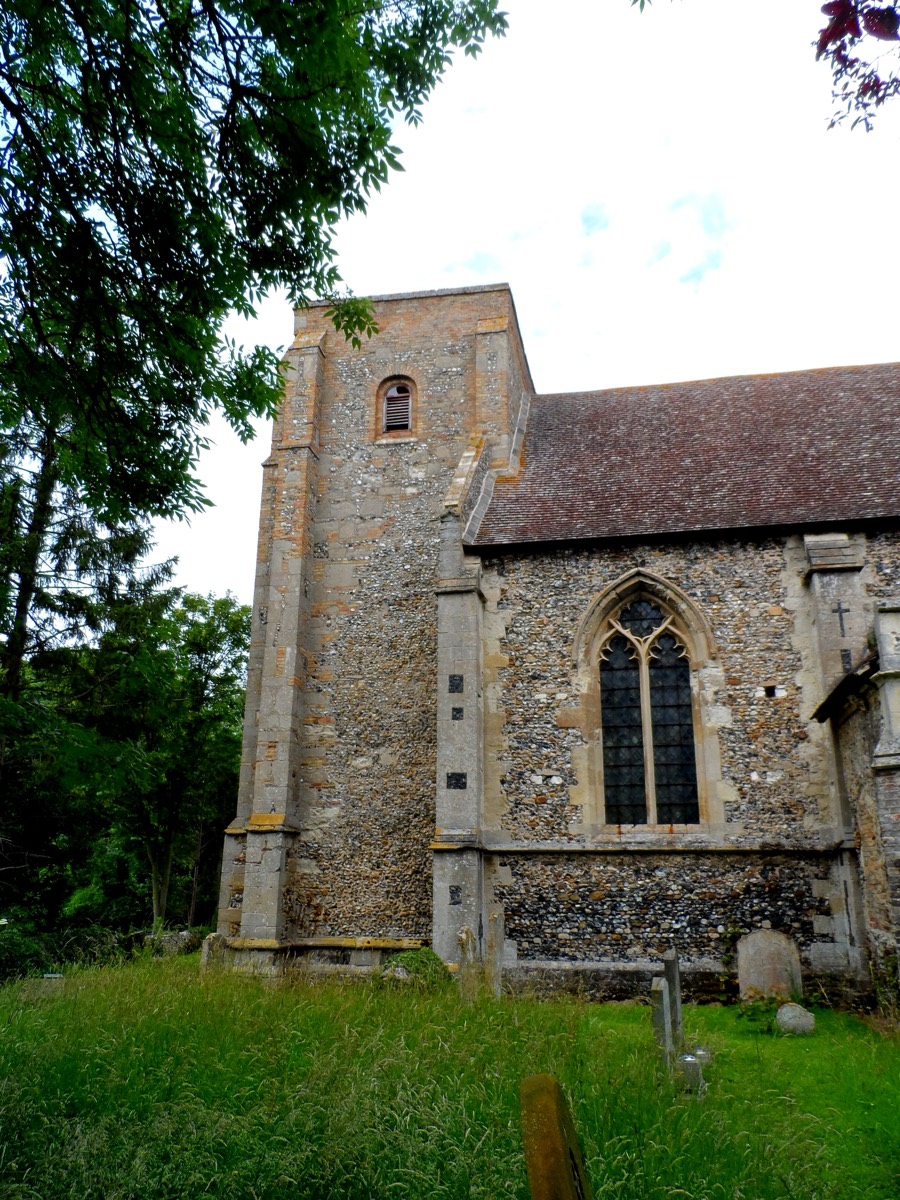 The west tower of St Mary's Church, Kentford, built of flint with stone dressings and a small pitched roof.