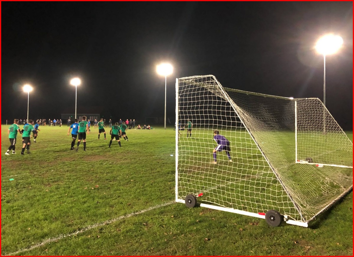 The MacLaren Playing Field football pitch under floodlights, with goalposts and open grass.